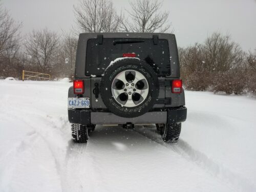 Rear view of Jeep Wrangler Unlimited in the snow