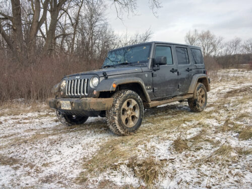 Front view of Jeep Wrangler Unlimited in mud